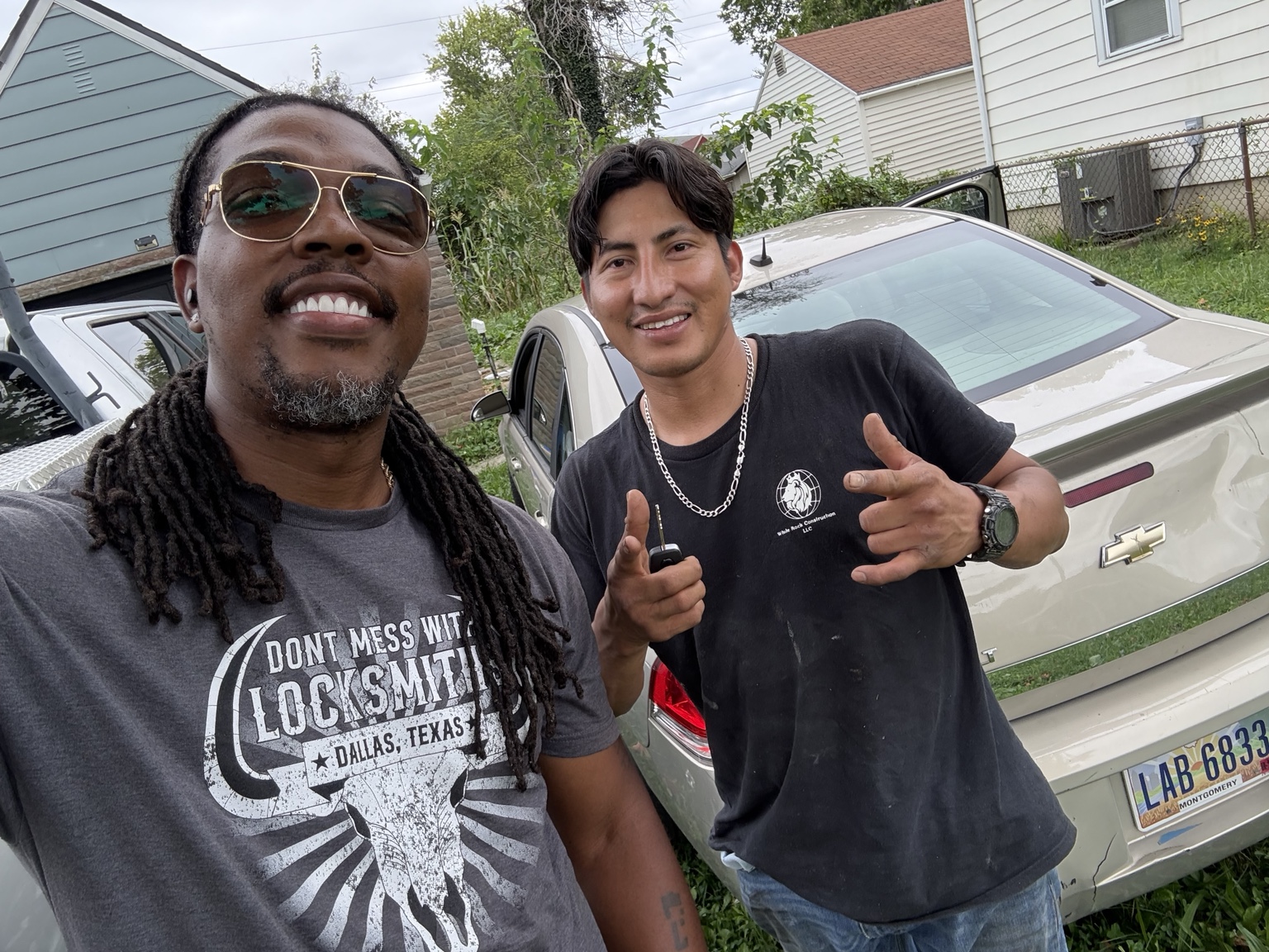 The Key Man with a customer beside a vehicle